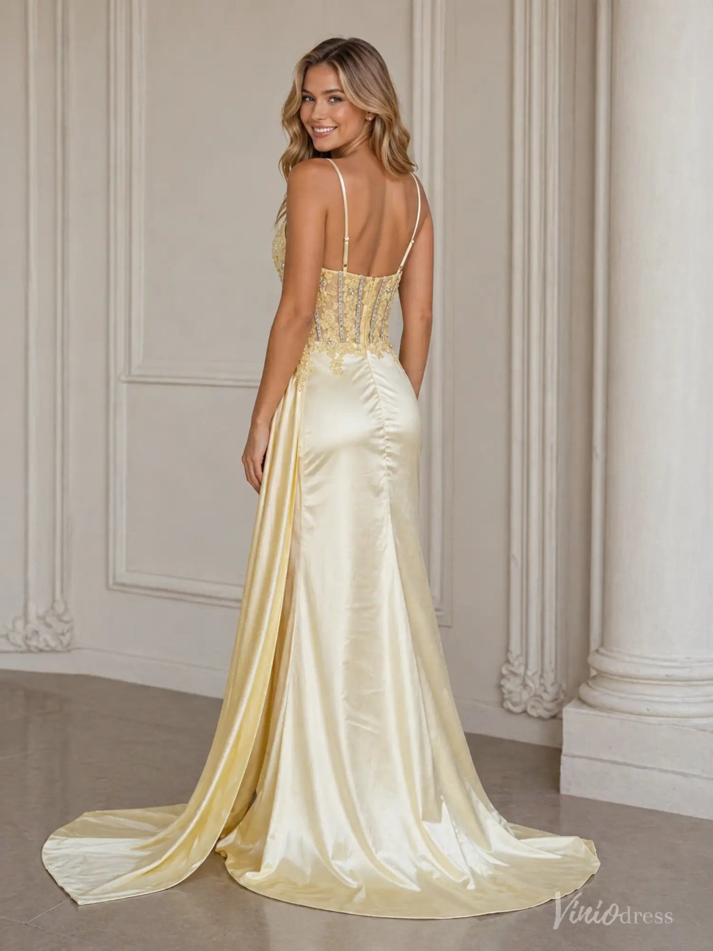 Yellow satin prom dress with a beaded corset bodice, spaghetti straps, and a flowing skirt with a side sash.