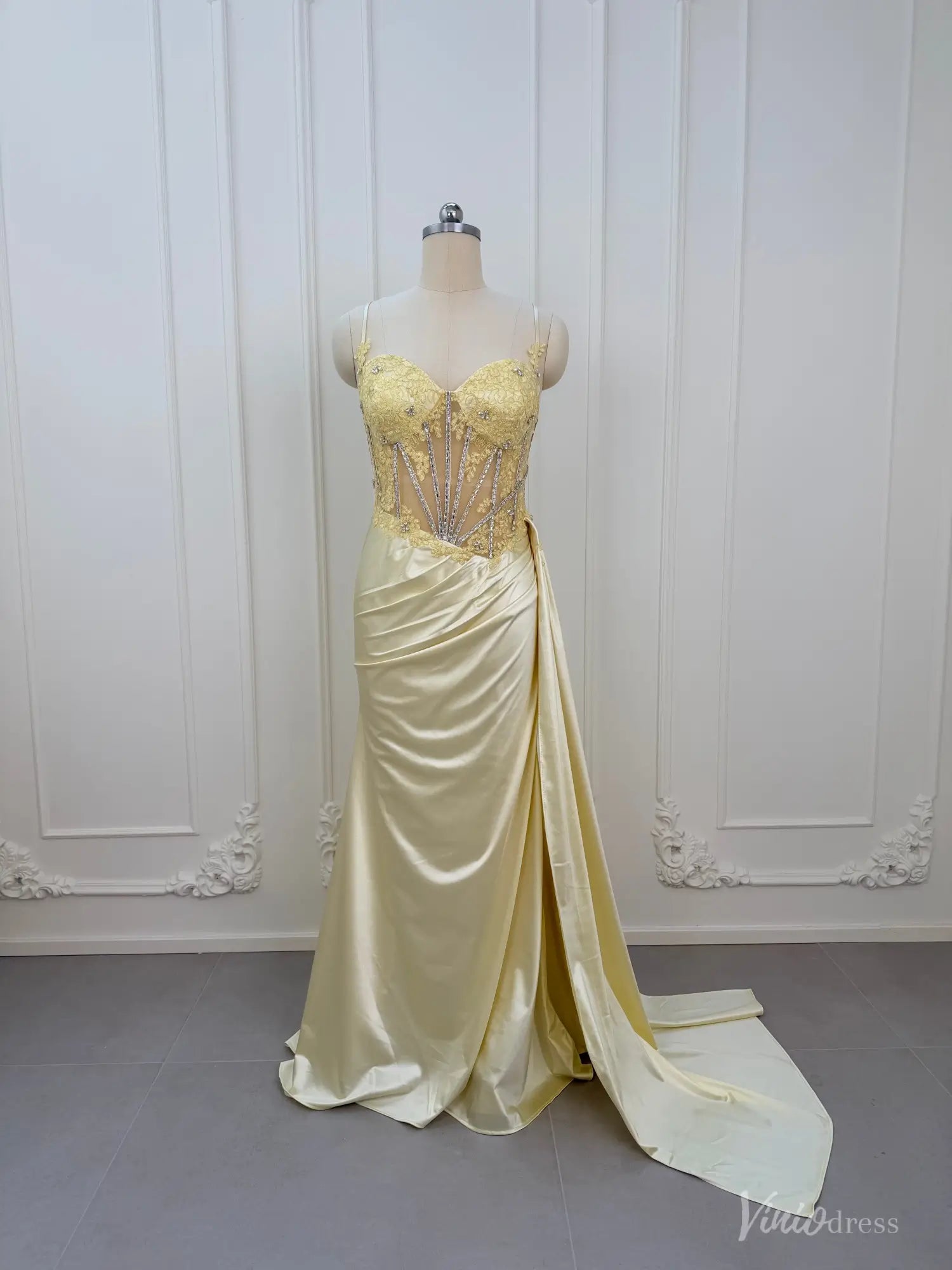 Yellow satin prom dress with a beaded corset bodice, sweetheart neckline, spaghetti straps, and a high-slit skirt.