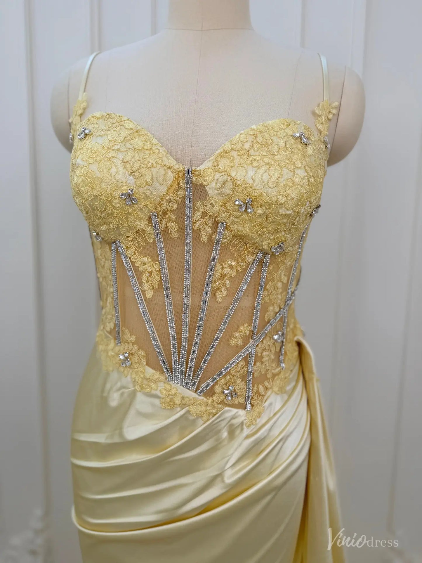 Yellow satin prom dress with a beaded corset bodice, sweetheart neckline, and delicate spaghetti straps.