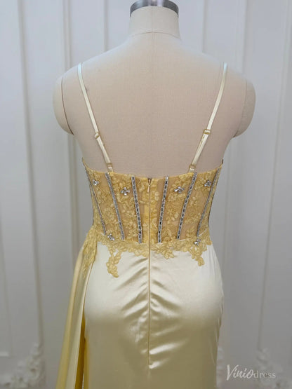 Back view of a yellow satin corset prom dress with a beaded bodice, spaghetti straps, and lace detailing on a mannequin.