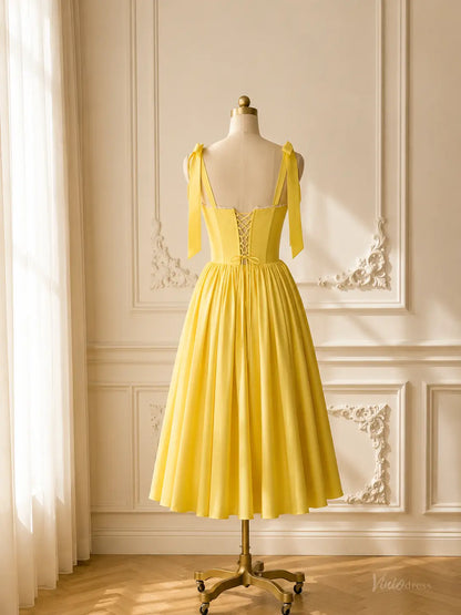 Yellow tea-length prom dress with a corset bodice, bow straps, and lace-up back on a mannequin.